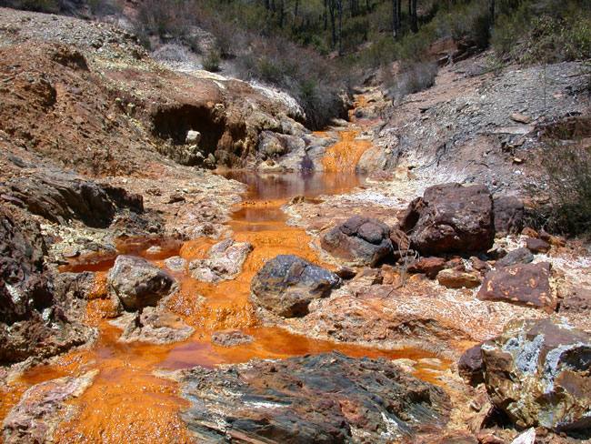 Orange water stained by acid mine drainage